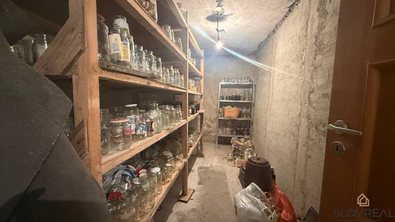A pantry in a family house with shelves full of glass jars.