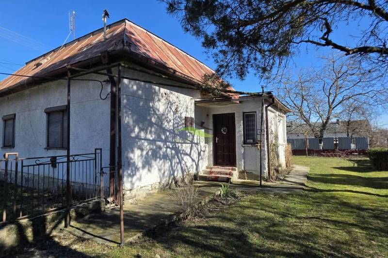 A family house in Pavlovce nad Uhom with a metal roof and a garden.