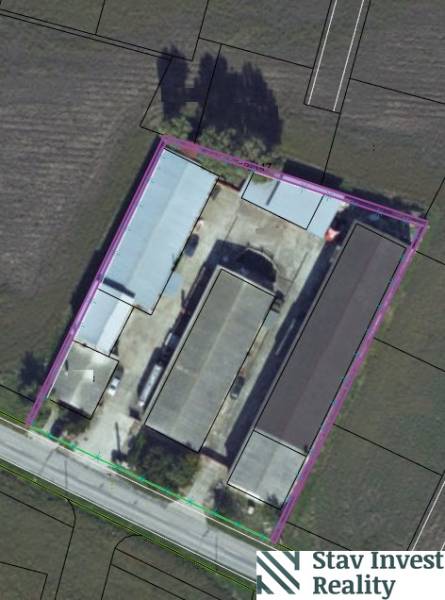 Aerial view of warehouses and halls in Jánovce surrounded by fields.