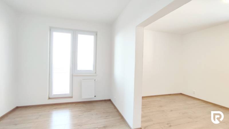A bright room with a wood-decor floor in a 2-room apartment.