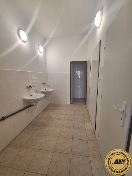 Bathroom with sinks and tiled walls, commercial spaces.