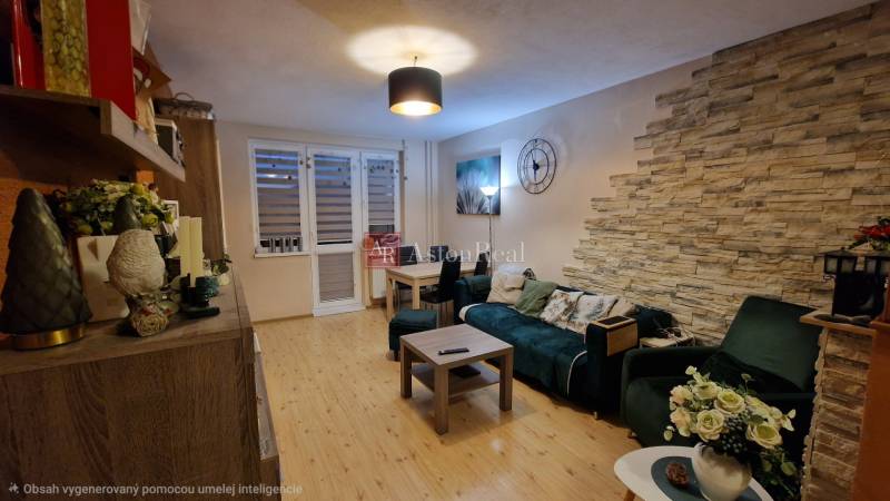 Living room in a 3-room apartment with a wooden decor floor and decorative elements.