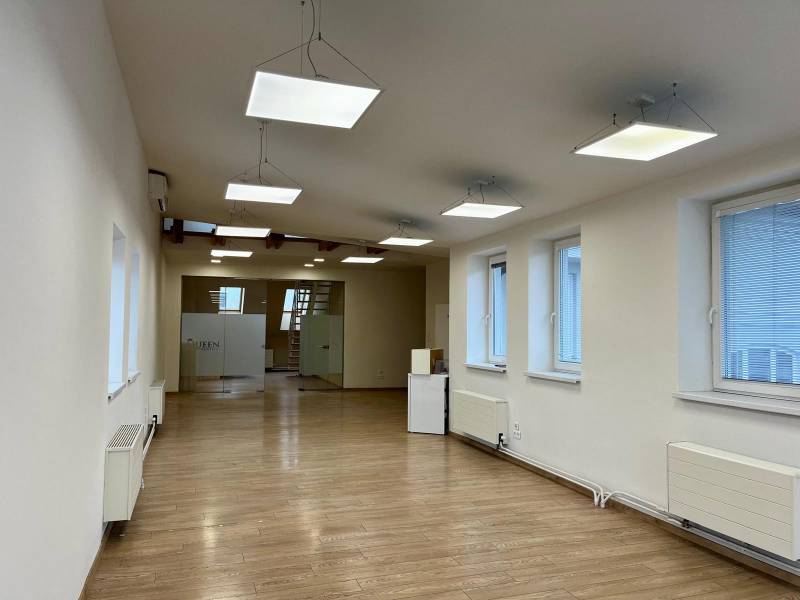 Offices with wood-patterned flooring, pendant lights, and glass doors.