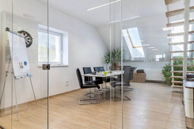 Glass walls, wood-patterned floor, and stairs in the office.