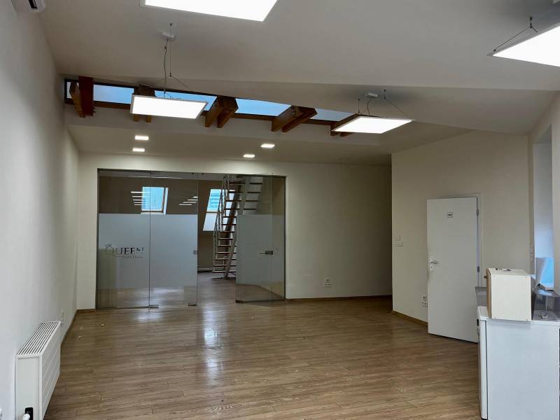 Offices with wood-patterned flooring, glass doors, and stairs.