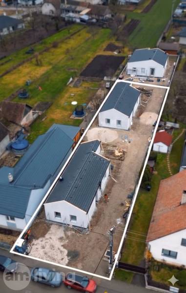 A residential area of family houses in Borčice surrounded by gardens and neighboring houses.