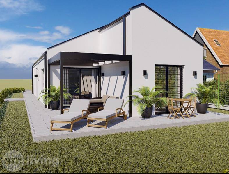 A family house in Borčice with a terrace, loungers, and garden furniture surrounded by a green lawn.