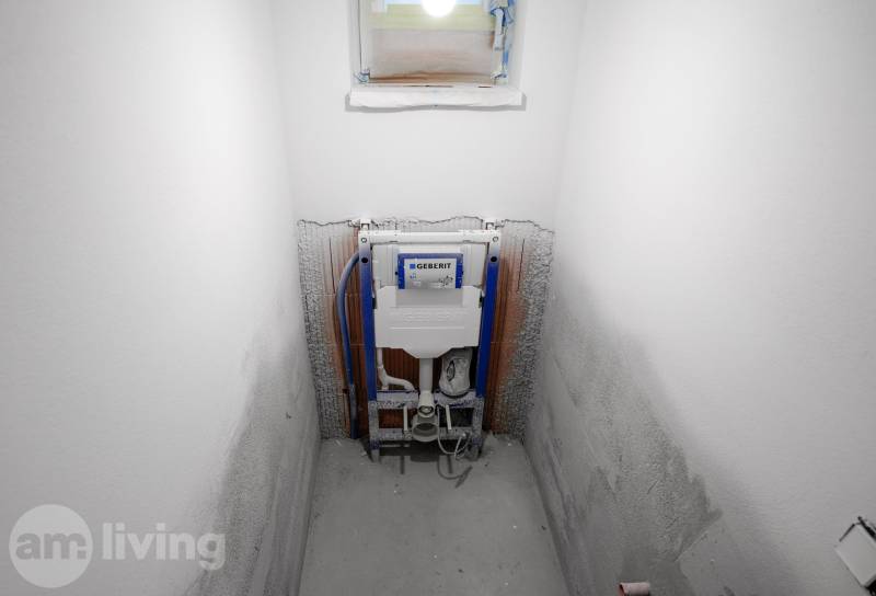 A bathroom under construction in a family house with the installation of a Geberit flushing system.