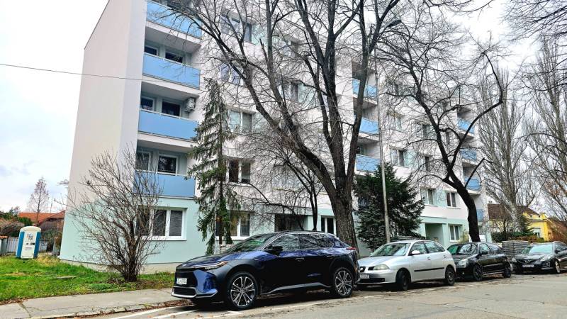 Pod Párovcami Street in Piešťany with an apartment building and parked cars in front of a 2-room apartment.