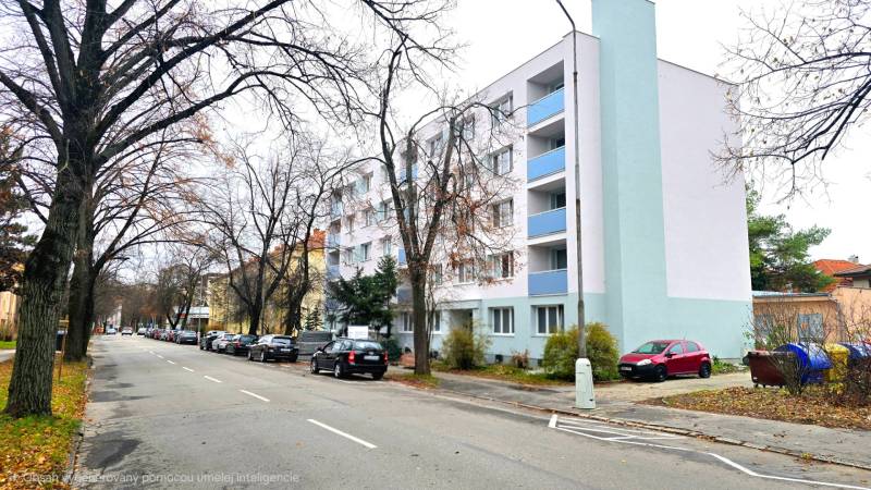 Pod Párovcami Street, Piešťany: A line of cars near a white building, not far from a 2-room apartment.