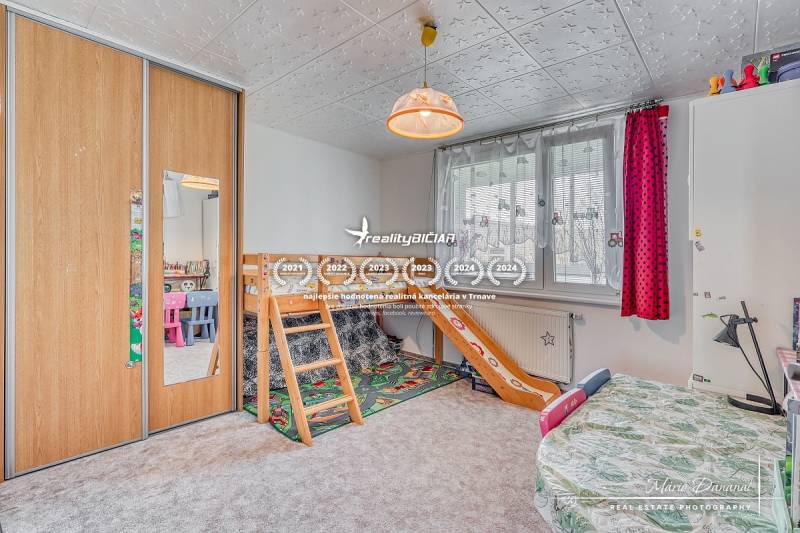 Children's room with a bunk bed, cabinets, and colorful chairs in a 4-room apartment.