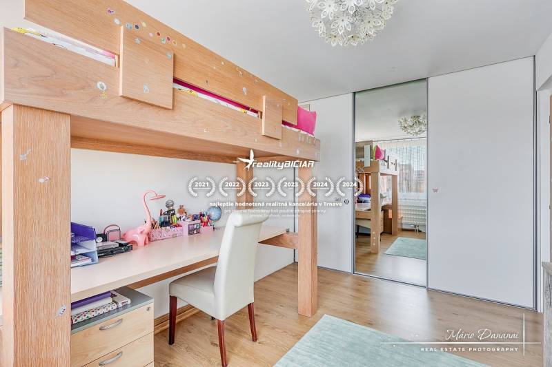 Children's room with a bed and a desk, wooden decor flooring, 4-room apartment.