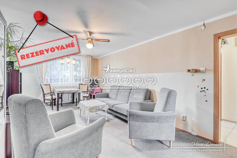Living room in a 4-room apartment with comfortable armchairs and a dining area.