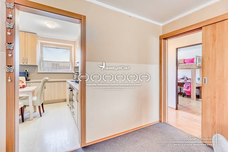 Kitchen and children's room in a 4-room apartment with a wooden decor floor.