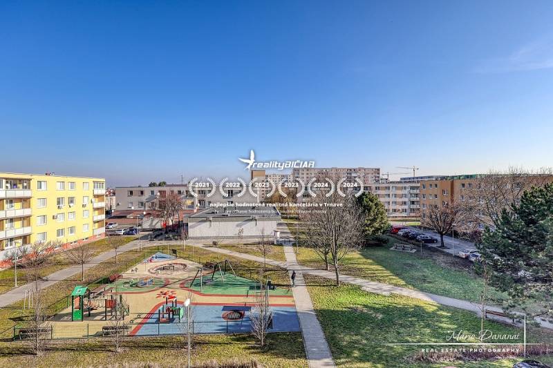 A playground surrounded by apartment buildings on Veterná Street in Trnava offers a view of a 4-room apartment.