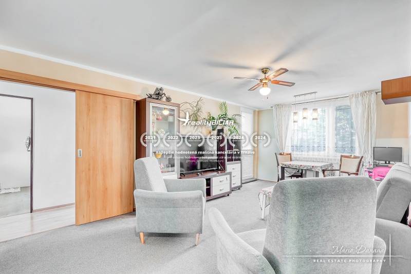 A bright living room with sofas in a 4-room apartment and a floor with a wooden decor.