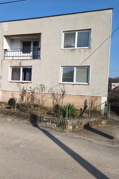 A family house in Mankovce, two-story with a balcony and an adjacent garden plot.