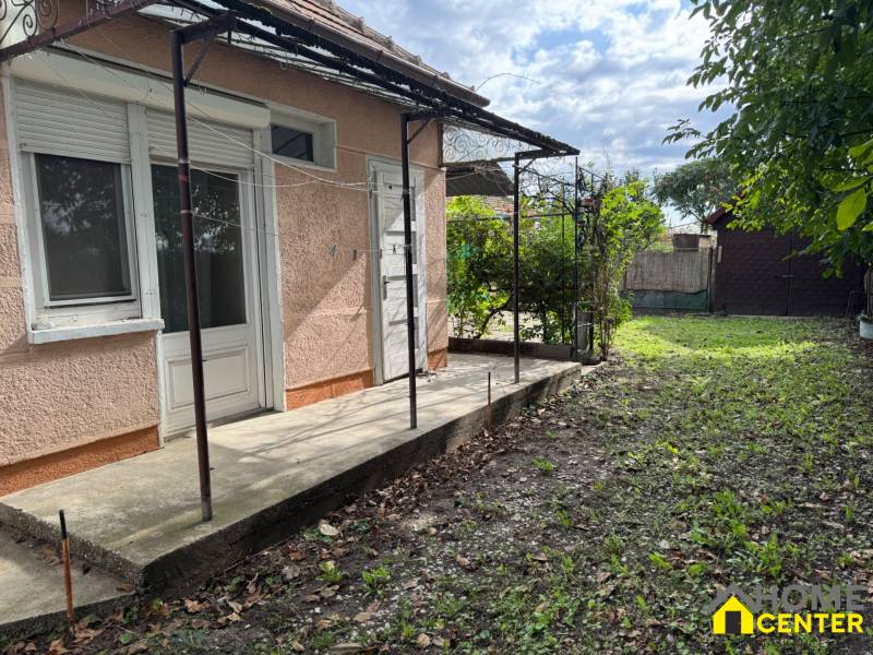 Family house in Komárno with a terrace and a grassy yard on a sunny plot.