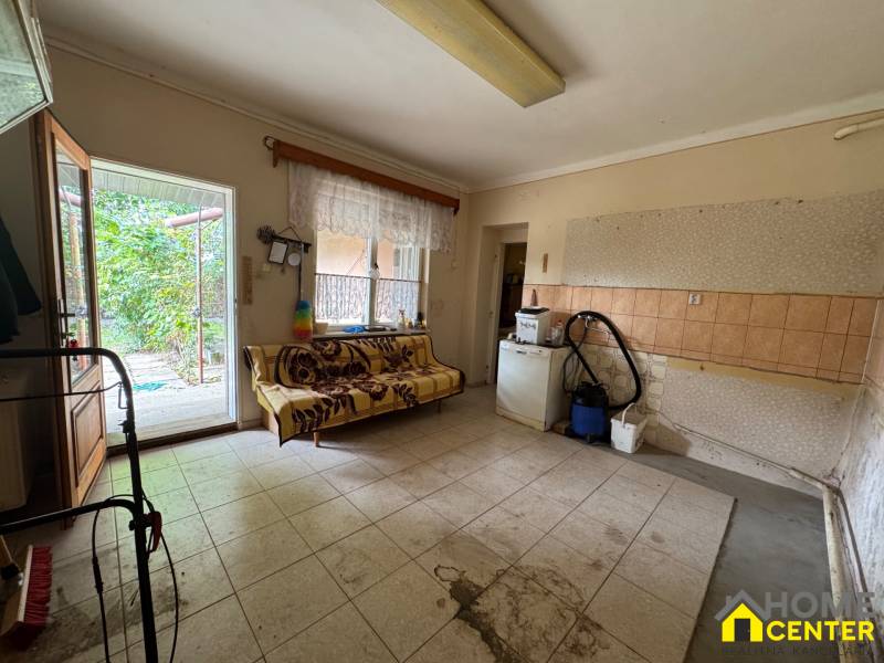 Interior of a family house with a sofa and direct access to the garden.