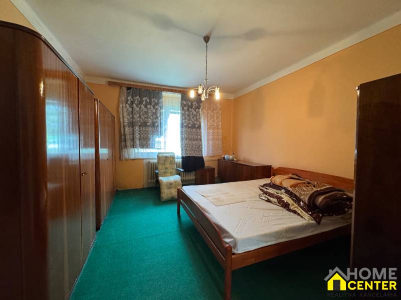 Bedroom in a family house with carpet and wooden furniture.