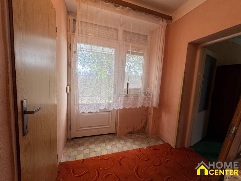 Interior of a family house with doors and curtains on the window, floor with checkered design.