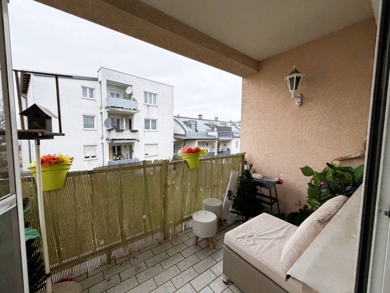 A balcony in a 3-room apartment with a view of a building in the town of Kittsee.