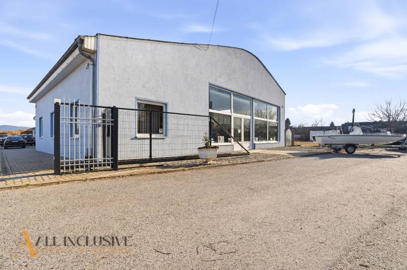 Commercial premises in Štúrovo with a gray facade, parking, and a shelter.