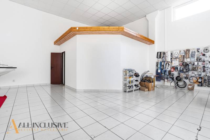 Commercial premises with white walls and ceramic flooring. Includes stored goods.