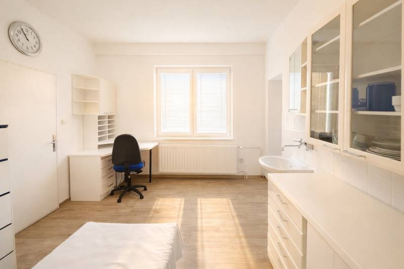 Offices with wood-patterned flooring, a desk, a sink, and cabinets.