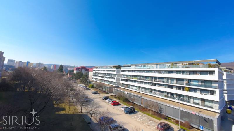 Apartment complex on Pri vinohradoch street in Bratislava - Rača, view of the park and parking lot.