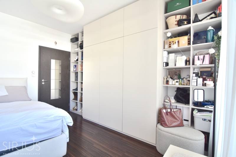 Bedroom in a 3-room apartment with storage spaces and a floor with a wooden decor.