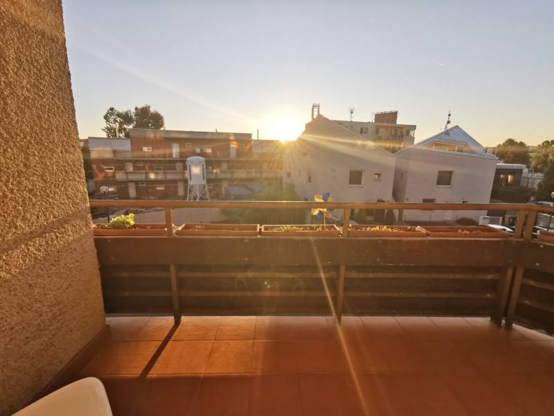 The balcony of a 4-room apartment on Priekopnícka Street in Bratislava - Podunajské Biskupice at sunset.