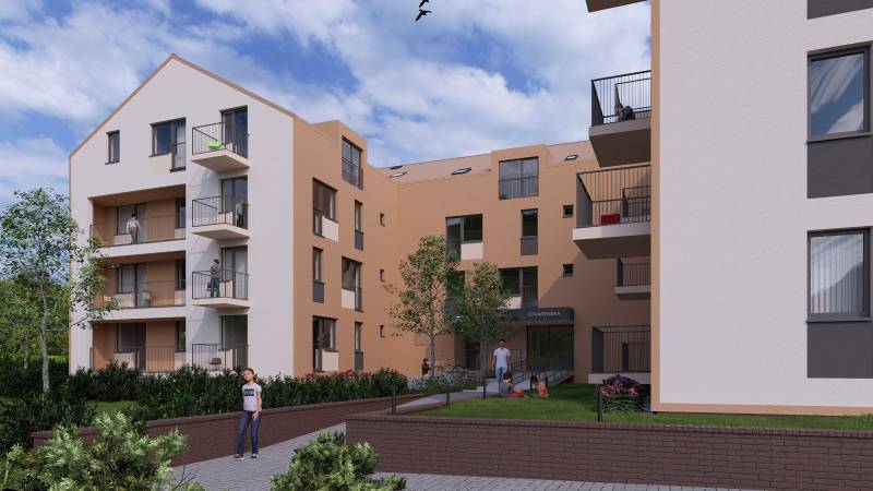 The exterior of a building with multi-storey apartments in the city of Poprad and people on the balconies.