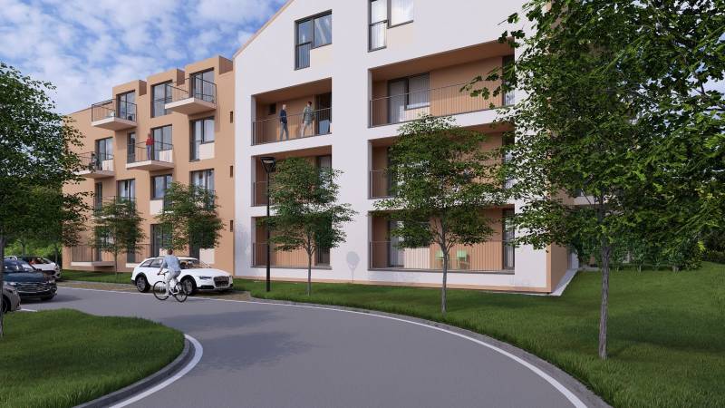 Apartment building in Poprad with a ramp, cyclist, and landscaped surroundings with greenery.