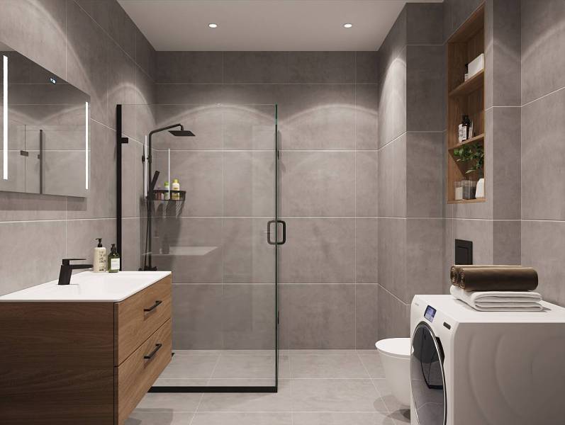 Bathroom with a sink, shower, and washing machine in a studio apartment.