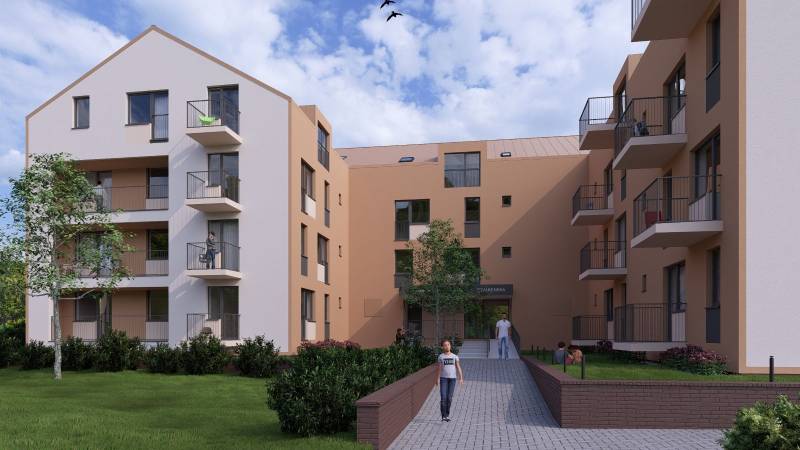 Residential building with trees and balconies in Poprad, suitable for a 1-room apartment.