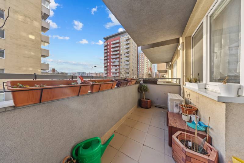The balcony of a 4-room apartment on Nejedlého Street in Bratislava - Dúbravka with flower pots.