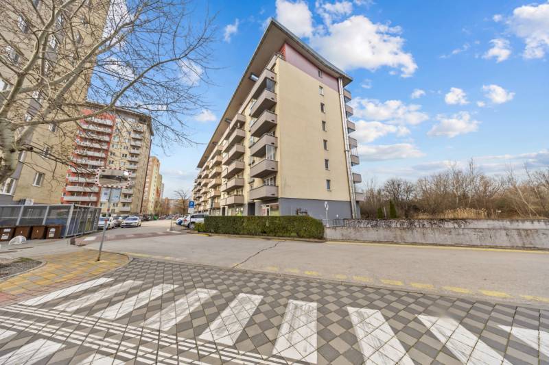 Apartment building on Nejedlého Street, Bratislava - Dúbravka, with balconies and a leafless tree.