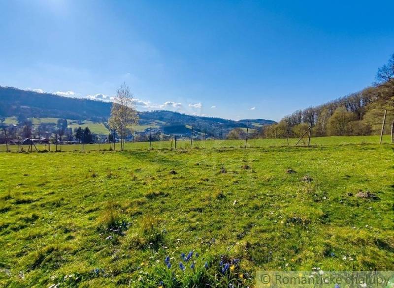 Gardens in Ľubietová with a view of the hills and blue sky.