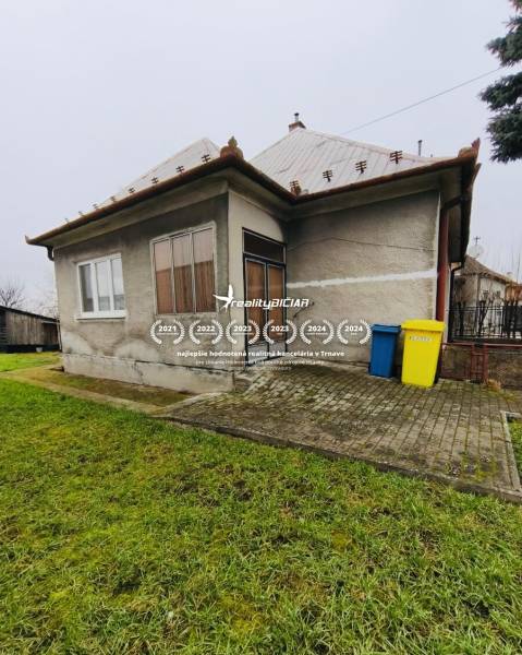 A family house on Seredska Street in Hlohovec with a small garden and a paved access area.