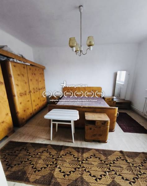 Bedroom in a family house with furniture, wooden decor flooring, carpet, lamp.
