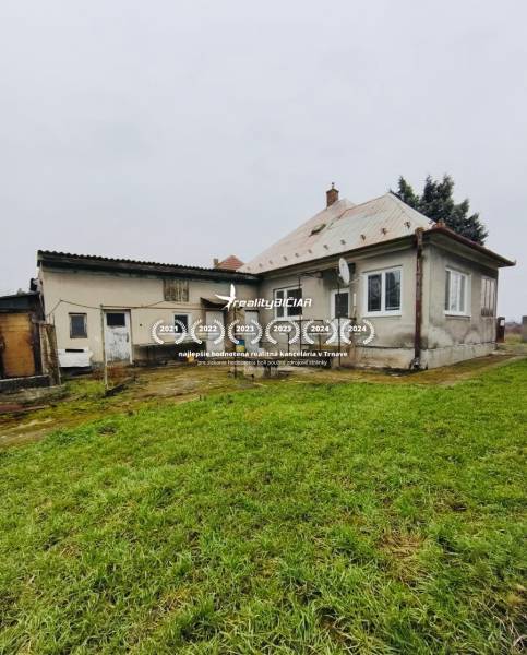 A family house on Seredska Street in Hlohovec with an older roof, garden, and plaster.