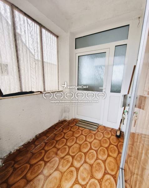 Interior of a family house with a wooden decor floor and glass doors.