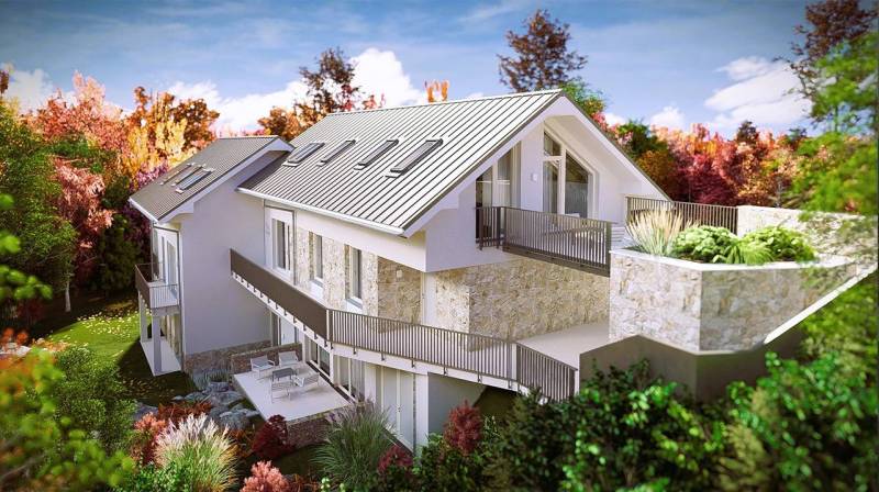 A family house in the High Tatras with a stone facade and a terrace surrounded by autumn nature.