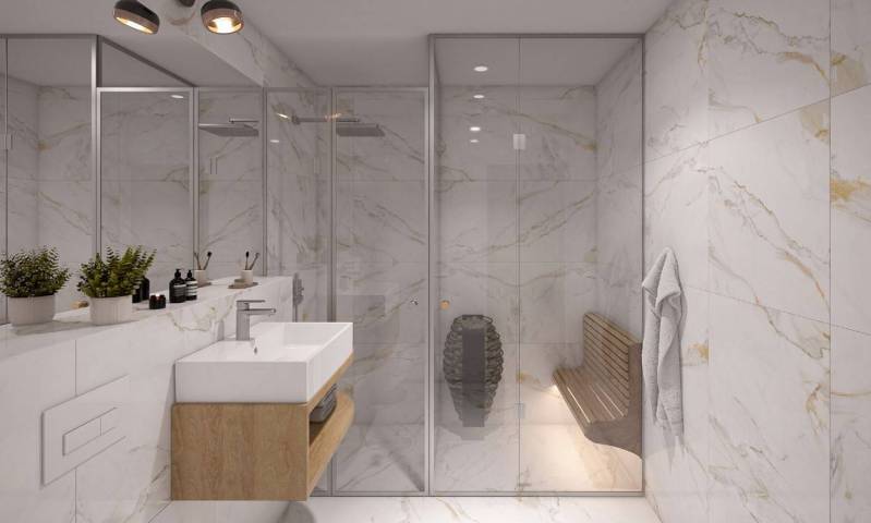 An elegant bathroom with a shower, mirror, and plants in a studio apartment.
