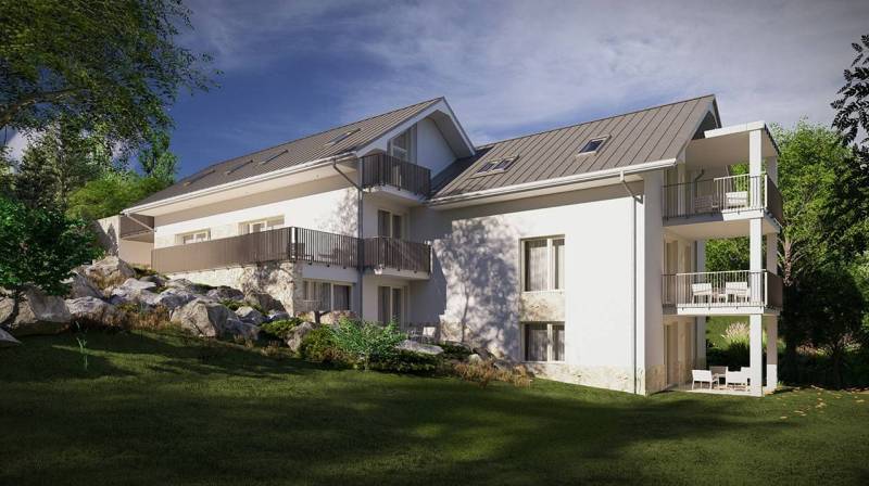 Exterior of a building in the High Tatras, surrounded by greenery and rocky terrain.