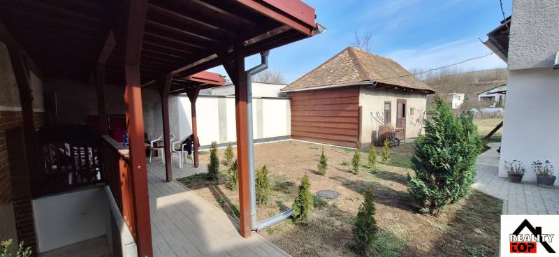 A family house in Gemerský Jablonec with a terrace and a landscaped garden.