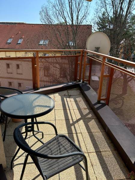 A balcony with seating in a 2-room apartment on Štefánikova Street in Poprad.