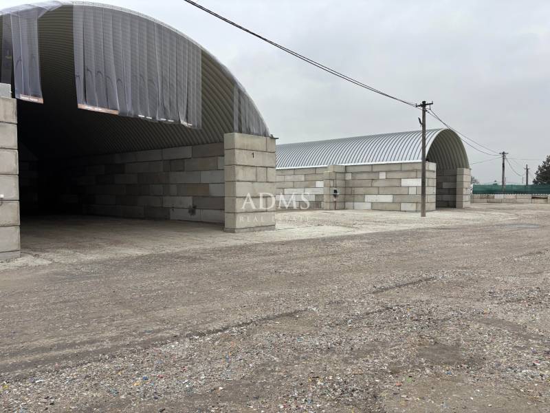 Warehouses and halls in the town of Ladce with arched roofs and concrete walls.