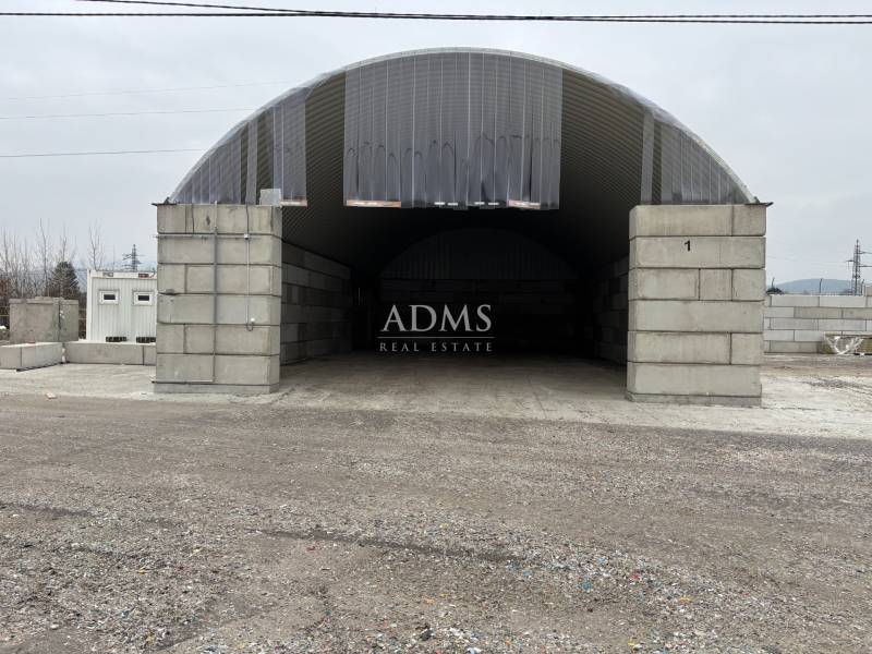 Warehouses and halls in Ladce with arched roofs and concrete entrances.